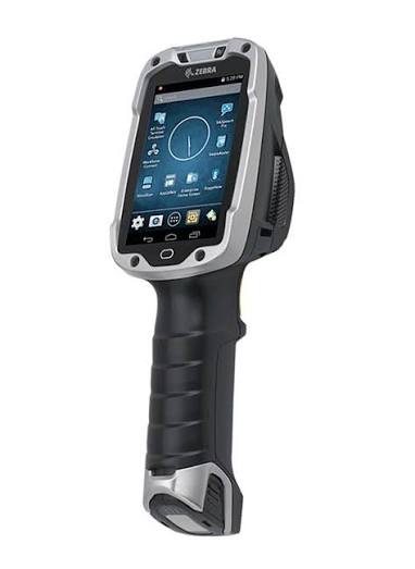A Zebra TC8000 seen from the front and slightly to one side — a grey and
                  black gun-grip touch computer with a square screen above the handle